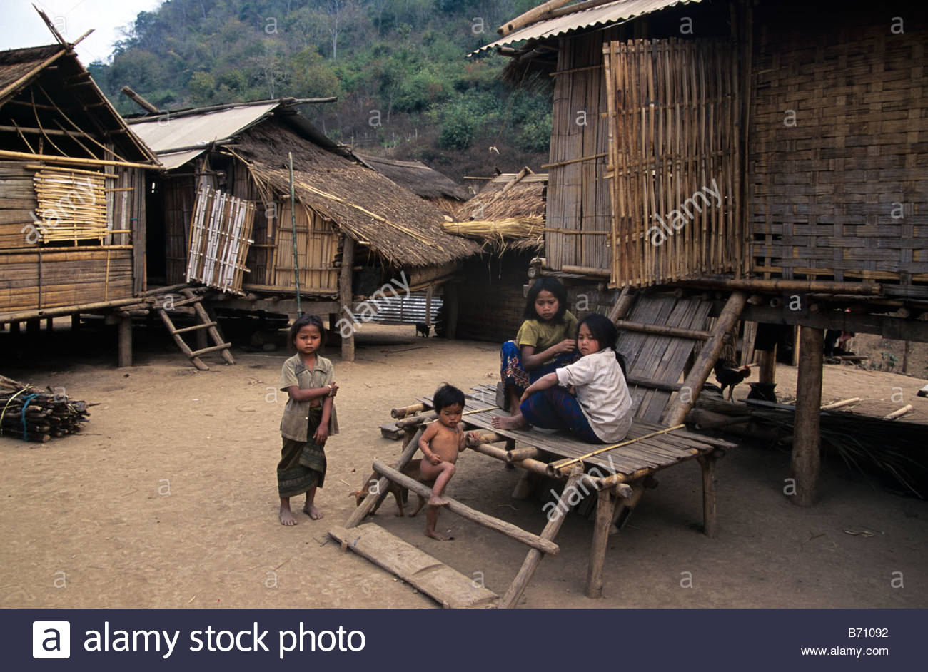 hmong-children-or-family-outside-their-traditional-bamboo-grass-houses-B71092.jpg