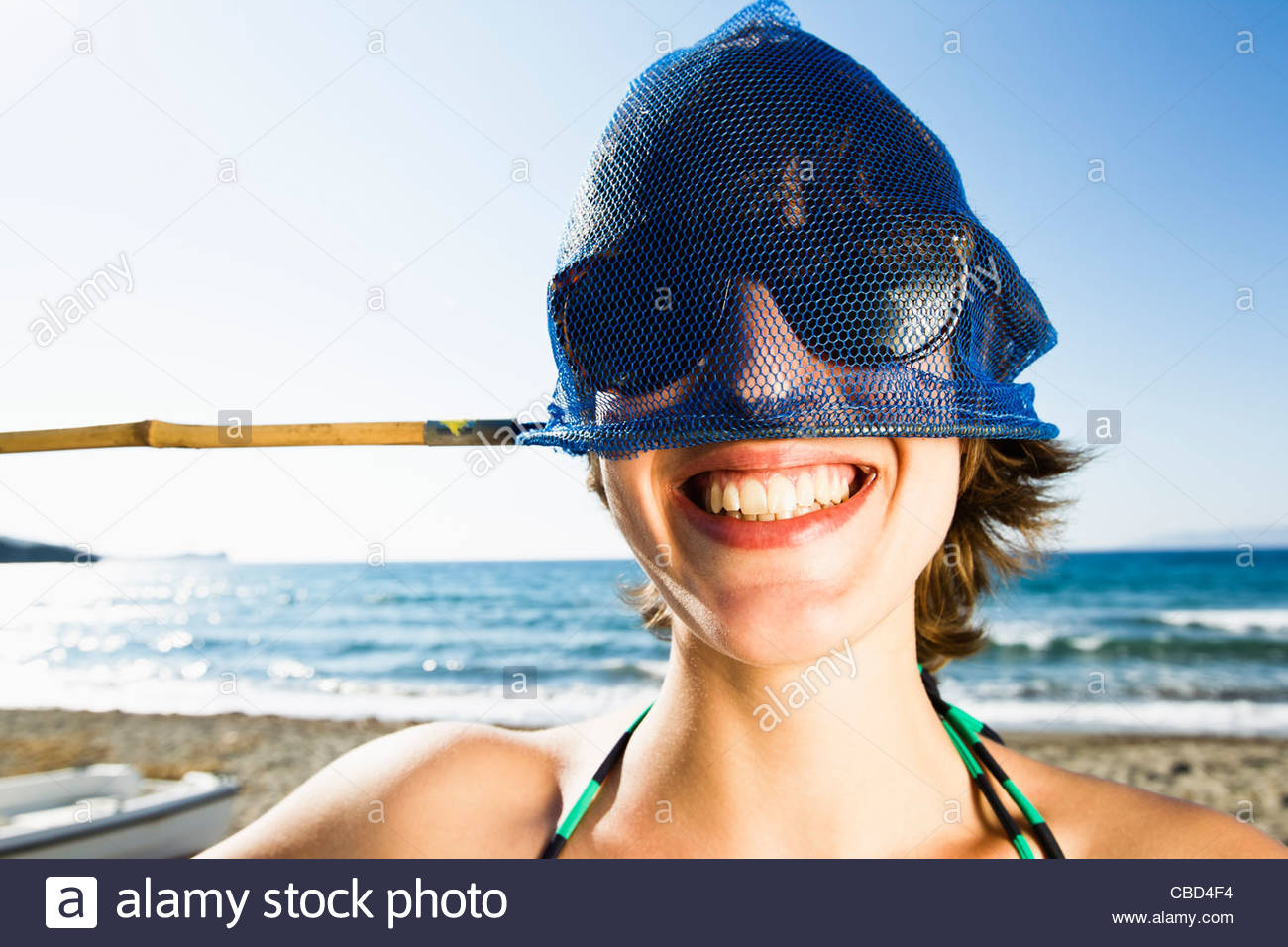 woman-holding-fishing-net-on-head-CBD4F4