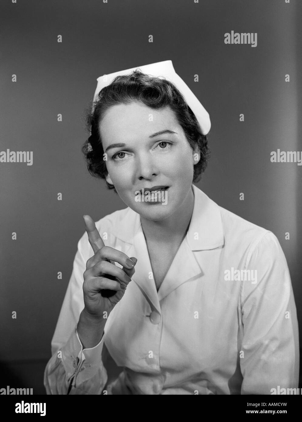 1950s-nurse-woman-portrait-wagging-one-f