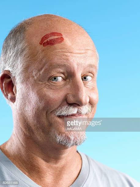 bald-man-with-mocking-smileand-a-lipstic
