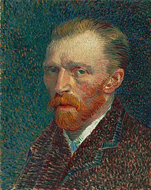 A head and shoulders portrait of a thirty something man, with a red beard, facing to the left